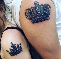 two women with tattoos on their arms and one has a crown