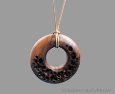 Boho Wood Necklace. This wood round necklace was made from walnut wood, carved, polished and finished with fine tung oil. This boho style wood necklace can be perfect gift for man or gift for woman.  THIS NECKLACE CAN BE COMBINED WITH EARRINGS THAT WOULD MATCH,  BY YOUR ORDER! The length of the cord is about 30 inches (77 cm), but it can be regulated by the movable knot. Materials utilised: pear wood, waxed cord Production method  100% hand made by natural materials. ABOUT ME My name is Nikolin Georgiev and I live in Sofia, Bulgaria. I love creating beauty therefore I make jewelry. I love colours and stones' emanation. I also love the soft warmth of wood as well as the glitter of the buffalo horn. I like natural materials and I enjoy combining them. I use whatever Mother Nature had given u Brown Carved Round Pendant Necklace, Walnut Necklace, Pear Wood, Tung Oil, Round Necklace, Wood Necklace, Nature Inspired Jewelry, Wood Pendant, Wood Carved