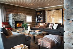 a living room filled with furniture and a fire place in the middle of it's walls