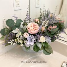 a flower arrangement in a bathroom sink