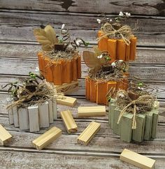 several small wooden blocks with plants growing out of them on top of a wood table