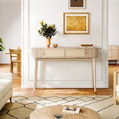 a living room filled with furniture and a plant on top of a wooden coffee table