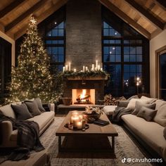 a living room filled with furniture and a lit christmas tree in the middle of it