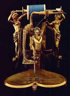 an antique clock with three figures on it