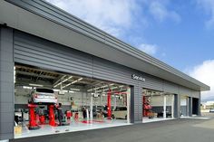 a car repair shop with cars in the garage