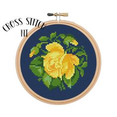 cross stitch kit with yellow flowers on blue background and text that reads cross stitch kit