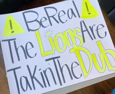 a sign that reads, be real the lions are taking the dubb