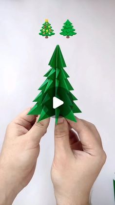 someone is making a christmas tree out of paper