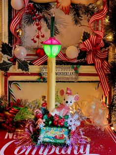 a lighted candle in the center of a christmas display