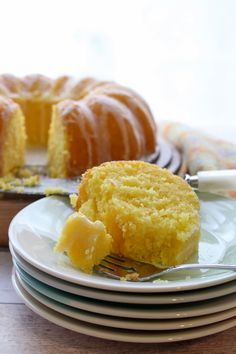 very lemon bundt cake from a box mix on a stack of plates with a fork