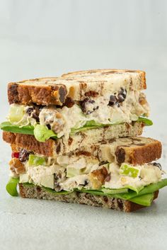 two halves of a chicken salad sandwich stacked on top of each other