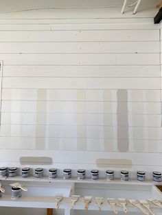 several paint colors are being used on the wall in an art studio with white walls