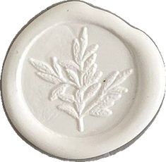 a white plate with a leaf design on it