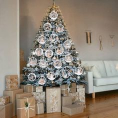 a decorated christmas tree with presents under it