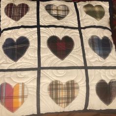 a quilt made to look like hearts on a bed