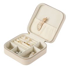 an open jewelry box filled with lots of rings