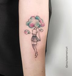 a woman with a cloud tattoo on her arm