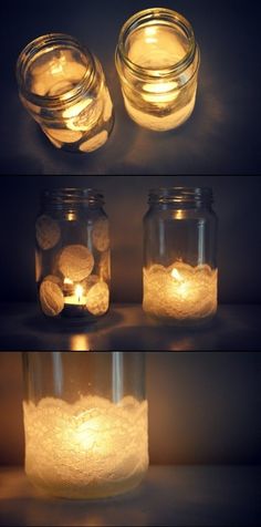 three mason jars filled with candles sitting on top of a table