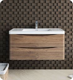 a bathroom with a sink and brown brick wall behind the sink is a wicker basket