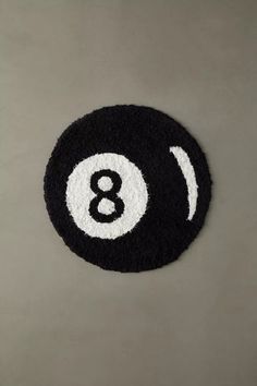 a black and white eight ball rug with the number 8 in it's center