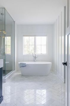 a white bath tub sitting inside of a bathroom