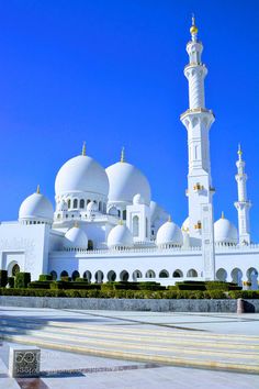 the large white building has many domes on it