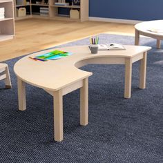 a child's table and chairs in a room with blue carpeted flooring