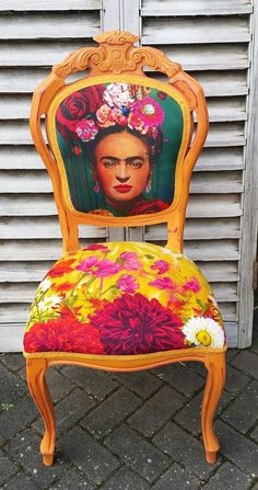 a wooden chair with an image of fridadora on it's back