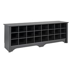 a black bookcase with many compartments on the top and bottom shelf, in front of a white background