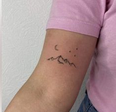 a woman's arm with a small tattoo on the left side of her arm