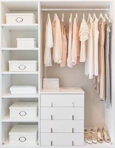 an organized closet with white drawers and clothes hanging on the racks, shoes and other items