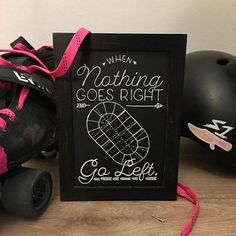 two roller skates sitting next to a chalkboard with the words, when nothing goes right go left