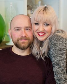 a man and woman are smiling for the camera