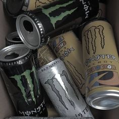 several cans of monster energy drink in a box