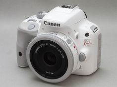 a white digital camera sitting on top of a table