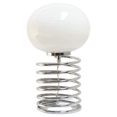 a white light that is on top of a metal stand with a ball attached to it