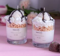 two desserts are sitting on a pink table