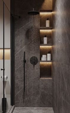 the shower head is illuminated by recessed lighting in this modern bathroom with gray marble walls and flooring