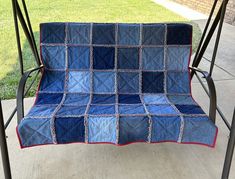 a blue and red quilted chair on a porch