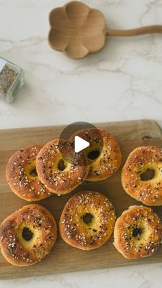 bagels with sesame seeds on a wooden cutting board