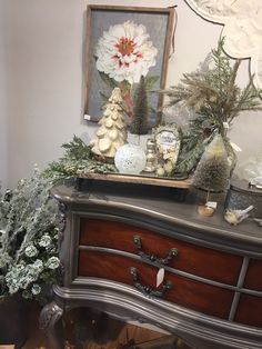 a dresser with christmas decorations on top of it