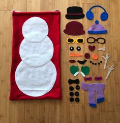 felt snowman and accessories laid out on the floor