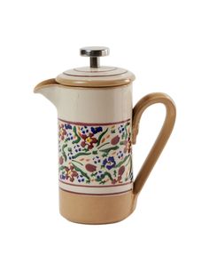 a ceramic coffee pot with floral designs on the front and bottom, sitting against a white background