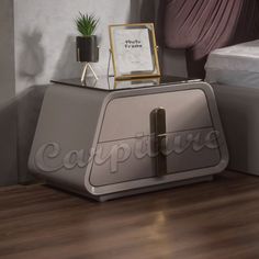 an old fashioned toaster sitting on top of a wooden floor next to a bed