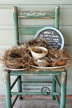 an old chair with some birds nest on it and a welcome sign in the back