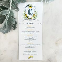 a menu card with flowers and leaves on the side next to a leafy plant