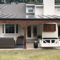 a white house with a covered porch and patio