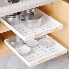 an open drawer with pots and pans on it