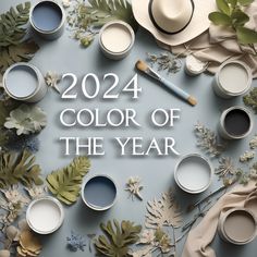 the words, color of the year are surrounded by paint cans and leaves on a blue background