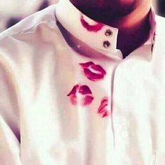 a man with red lipstick painted on his shirt